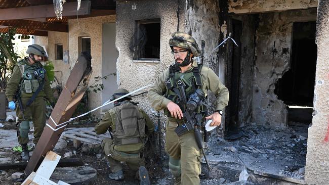 Israeli soldiers cordon off an area in Kibbutz Beeri near the border with the Gaza Strip.