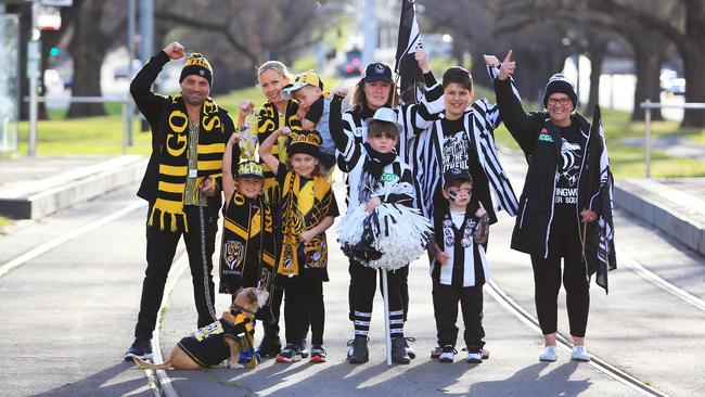 Fans converge on the corner of Hoddle and Victoria streets yesterday. For the Tigers, Jess and Anthony Aloi with children Arabella, Alfie and Charlie; and for the Pies, Ebony Smith, Kerri Watts, Damion Lumani, Mason Banting and Lorraine Boateng. Picture: Aaron Francis