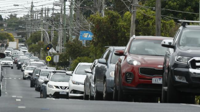 People queue up in their cars stretching approximately 1km for a COVID19 test at a pop-up test site in Parkdale, Melbourne. Picture: Daniel Pockett / The Australian