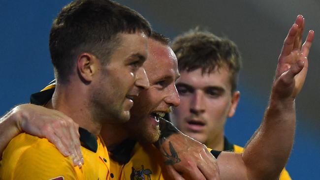 Australia's defender Rhyan Grant (2nd L) reacts with teammates after scoring during the FIFA World Cup Qatar 2022 qualifying round Group B football match against Australia at the My Dinh National Stadium in Hanoi on September 7, 2021. (Photo by Manan VATSYAYANA / AFP)