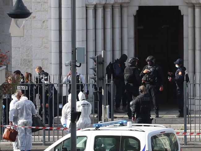 Members of the elite tactical police unit enter the Basilica of Notre-Dame de Nice as forensics officers wait outside after a knife attack in Nice. Picture: AFP