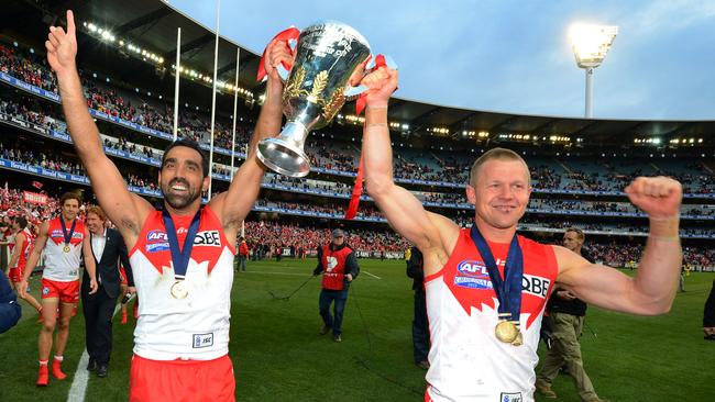 Sydney’s Adam Goodes and Norm Smith medallist Ryan O'Keefe hold the 2012 AFL trophy.