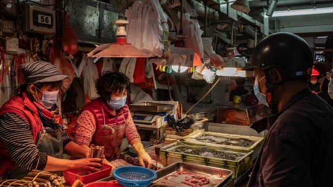 Residents wearing face mask purchase seafood at a wet market on January 28, 2020 in Macau, China. The popularity of wet mrkets is declining, according to industry experts. Photo by Anthony Kwan/Getty Images.