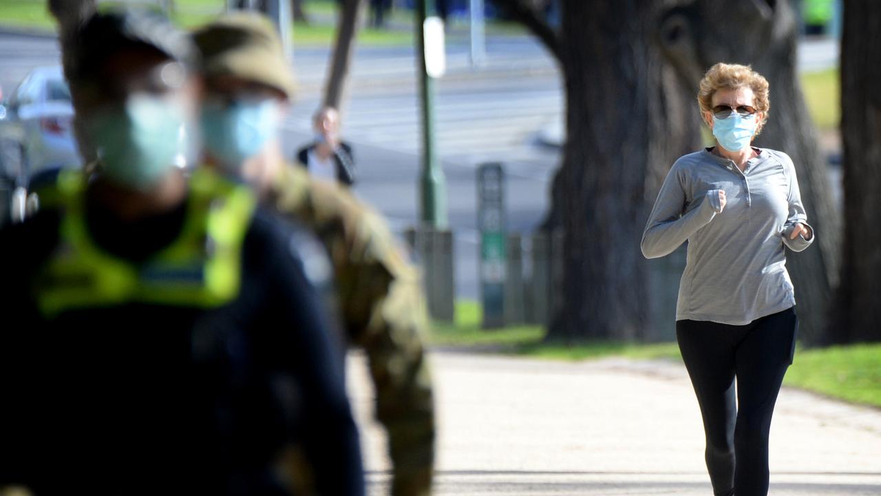 Police and ADF personnel patrol the Tan track in Melbourne. Picture: NCA NewsWire / Andrew Henshaw