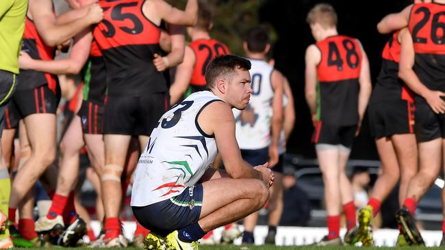 Manningham Cobras’ Timothy Somerville ponders what might have been while Aquinas celebrates. Picture: Andy Brownbill