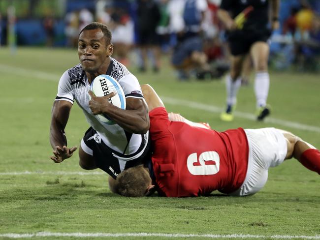 Fiji’s Osea Kolinisau scores a try as Britain’s Tom Mitchell defends.