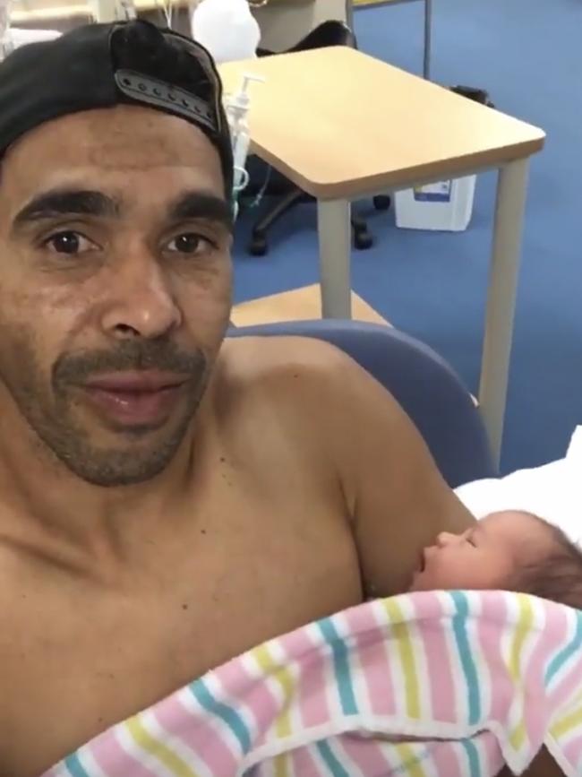 Eddie Betts with one of his newborn twin daughters.