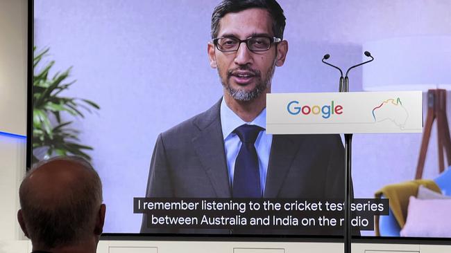 Google CEO Sundar Pichai announces the company's $1bn investment in Australian technology research on a video feed as Australian PM Scott Morrison (left, front) watches on at Google’s launch event.