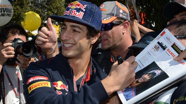 A young Ricciardo signs autographs for fans in 2012.