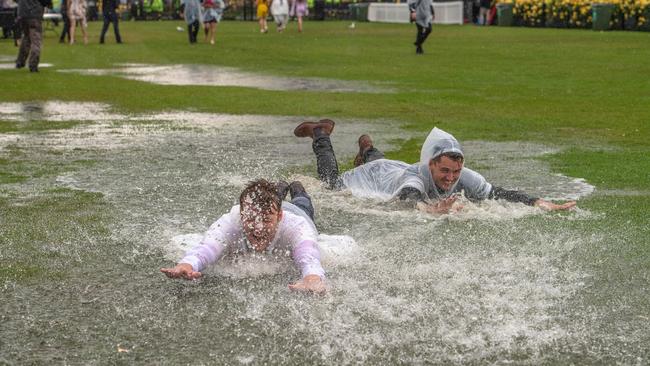 Punters making the best of a bad situation. Picture: Jason Edwards