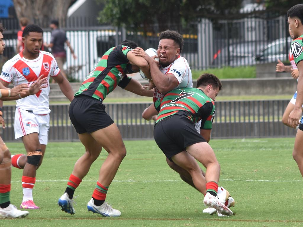 Cyrus Stanley-Traill is tackled by Tylah Slate (left) and Matthew Humphries. Picture: Sean Teuma