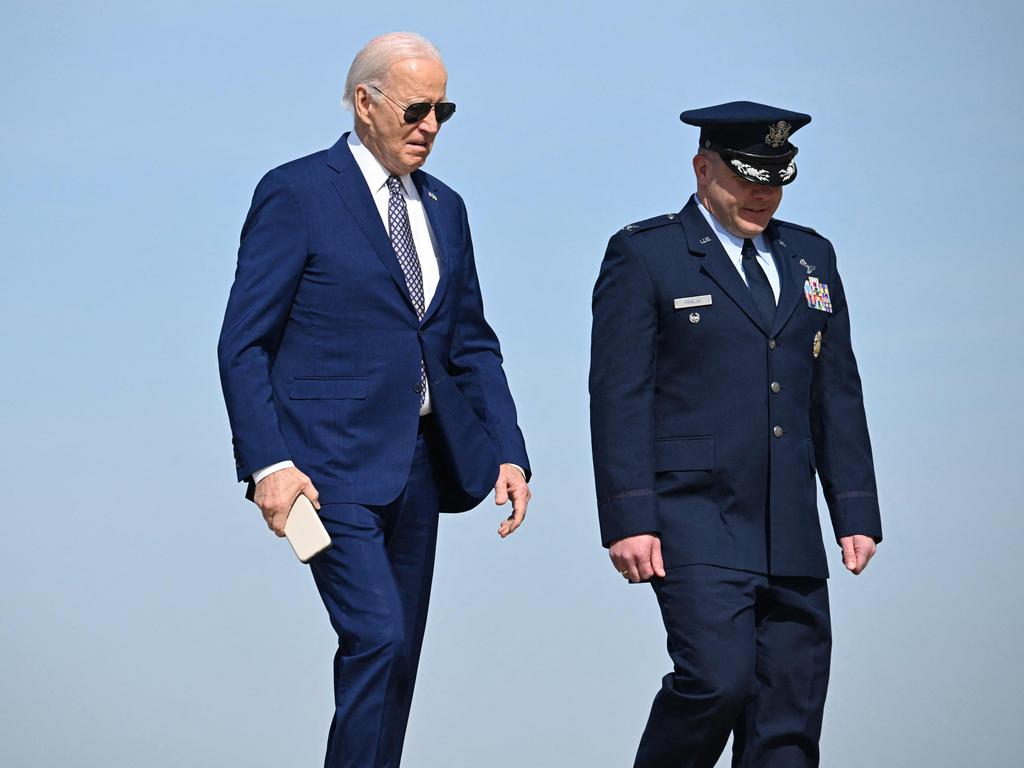 Joe Biden walks alongside US air force Colonel Paul Pawluk as he arrives at Joint Base Andrews in Maryland to board Air Force One. Picture: AFP