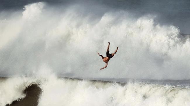 Amber Cowley was trying out a new camera at the Bluff at Alexandra Headland on the Sunshine Coast when she captured this stunning photograph of 'falling man'.  "Not sure if he caught some air or forgot his parachute.... The stoke was palpable there today & for a moment Iâ&#128;m pretty sure everyone forgot about the impending Alfred."