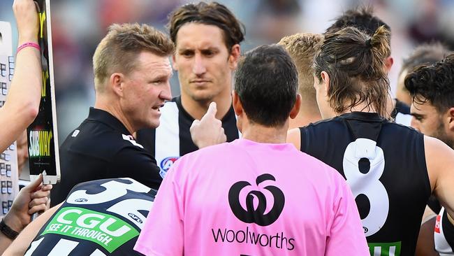 MELBOURNE, AUSTRALIA - APRIL 17: Nathan Buckley the coach of the Magpies talks to his players during the round four AFL match between the Collingwood Magpies and the Melbourne Demons at Melbourne Cricket Ground on April 17, 2016 in Melbourne, Australia. (Photo by Quinn Rooney/Getty Images)