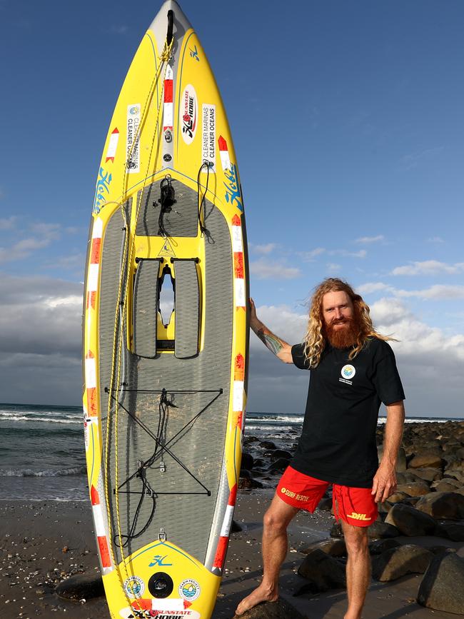 Charity paddle-boarder Ben Ferris pictured at Burleigh Heads as part of his coastal epic journey. Photograph : Jason O'Brien