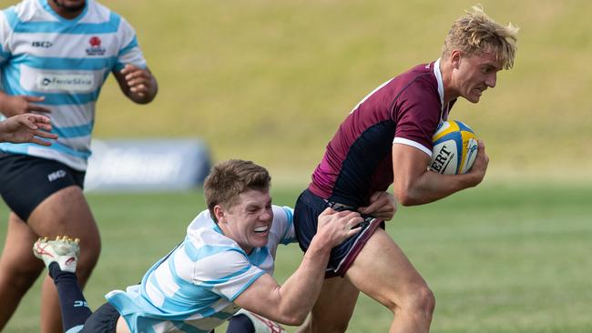 NSW’s Johannes Logan tackles Queensland’s Tyler Stevens. Picture: Julian Andrews