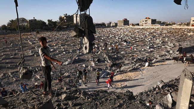 A Palestinian child boy stands on what remains of a balcony of a flat hit by overnight Israeli bombing in Rafah in the southern Gaza Strip on April 20. Picture: AFP