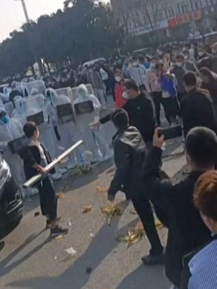 Workers at Foxconn's iPhone factory in Zhengzhou in central China clash with riot police as well as people wearing hazmat suits. Photo by AFPTV teams.