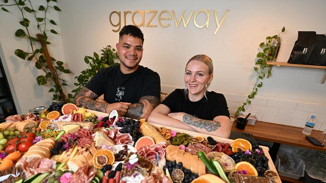 Grazeway Nerang owners Christian Boluch and Akita Bysouth-Young, pose with a 1.2m grazing board. Picture: Dan Peled