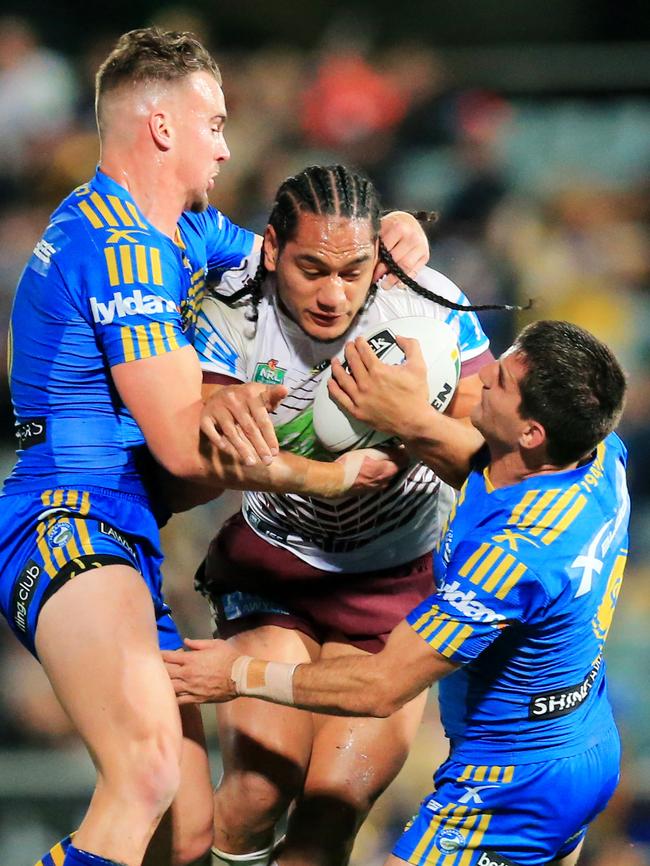 Marty Taupau tackled by Clint Gutherson and Isaac De Gos during the game with Parramatta. Picture:  Mark Evans