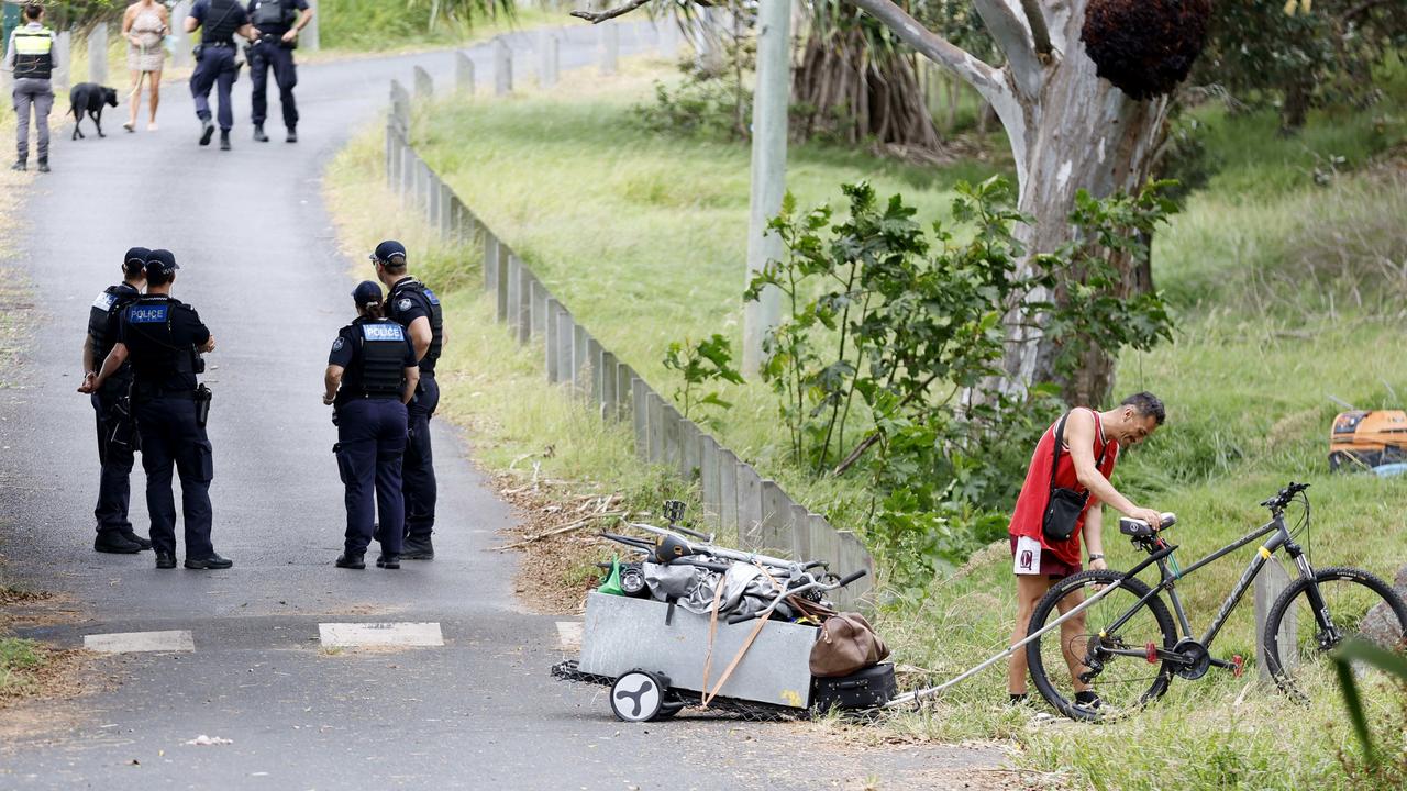 Police at the site as residents pack up to leave. Picture: Josh Woning