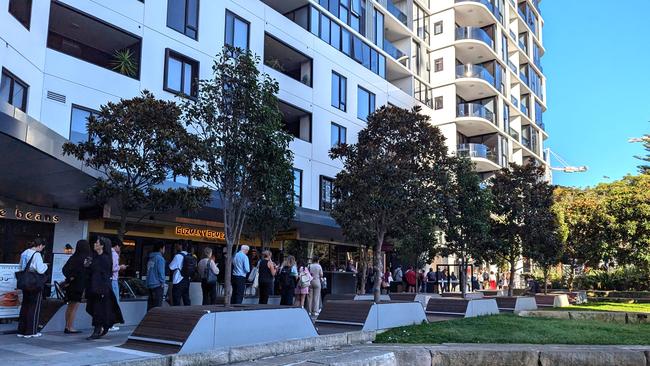 Queues for the B-Line stretched 200 to 300 metres around the block at Dee Why on Tuesday. Picture: Gillian McKenna