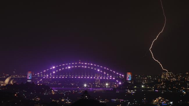 Lightning strikes over the Sydney Harbour Bridge during stormy weather just hours before New Year’s. Picture: Toby Zerna 