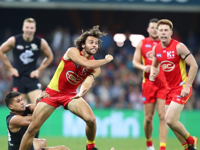 Lachie Weller of the Suns handballs during the round 19 AFL match between the Gold Coast Suns and the Carlton Blues at Metricon Stadium on July 28, 2018 in Gold Coast, Australia. Picture: Chris Hyde/Getty Images.