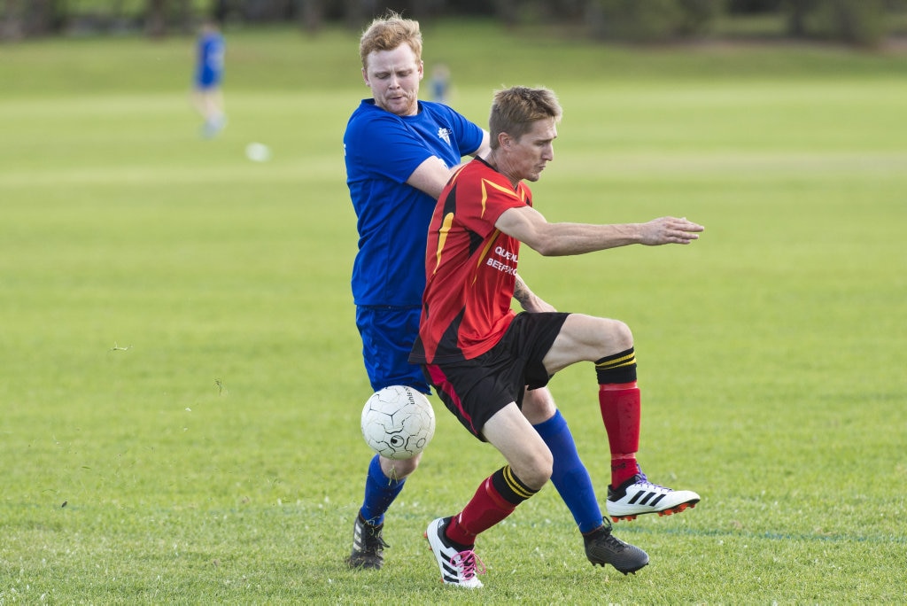 Rockville player Aaron Chalmers (left) battles with Brendan Newby of Gatton in Toowoomba Football League Premier Men round six at Captain Cook ovals, Sunday, April 7, 2019. Picture: Kevin Farmer