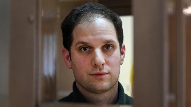 TOPSHOT - US journalist Evan Gershkovich looks out from inside a defendants' cage before a hearing to consider an appeal on his extended pre-trial detention, at the Moscow City Court in Moscow on Tuesday. Picture: Natalia Kolesnikova/AFP