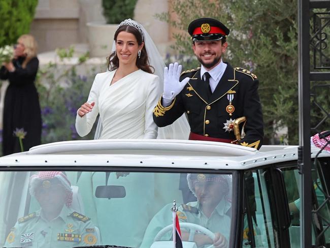 Crown Prince Hussein of Jordon and his wife Saudi Rajwa al-Seif wave as they leave the Zahran Palace in Amman. Picture: AFP