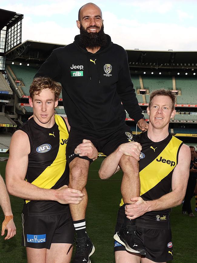 Bachar Houli is chaired off by Tom Lynch and Jack Riewoldt. Picture: Michael Klein