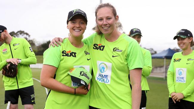 Sam Bates of the Thunder presents a Thunder cap to debutant Olivia Porter. Photo by Brendon Thorne/Getty Images