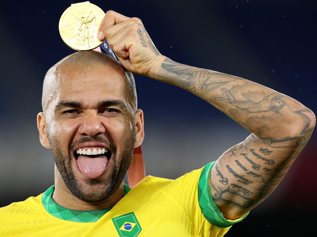 Alves, pictured with Olympic gold in August, is expected to make his second debut for Barcelona next week aged 38 and could also go to the World Cup with Brazil later in 2022. Picture: Alexander Hassenstein/Getty Images