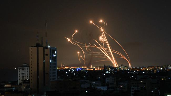 An Israeli missile launched from the Iron Dome defence missile system attempts to intercept a rocket, fired from the Gaza Strip, over the city of Netivot in southern Israel. Israel, reeling from the deadliest attack on its territory in half a century, formally declared war on Hamas Sunday as the conflict's death toll surged close to 1,000 after the Palestinian militant group launched a massive surprise assault from Gaza. Picture: Mahmud Hams