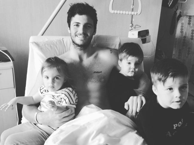 Dylan Roberton in hospital with his three children. Picture: St Kilda FC