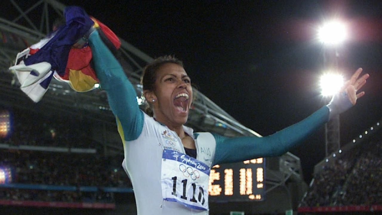 Cathy Freeman holds the Aboriginal and Australian flags as she celebrates her win in the women's 400m at the 2000 Sydney Olympic Games.