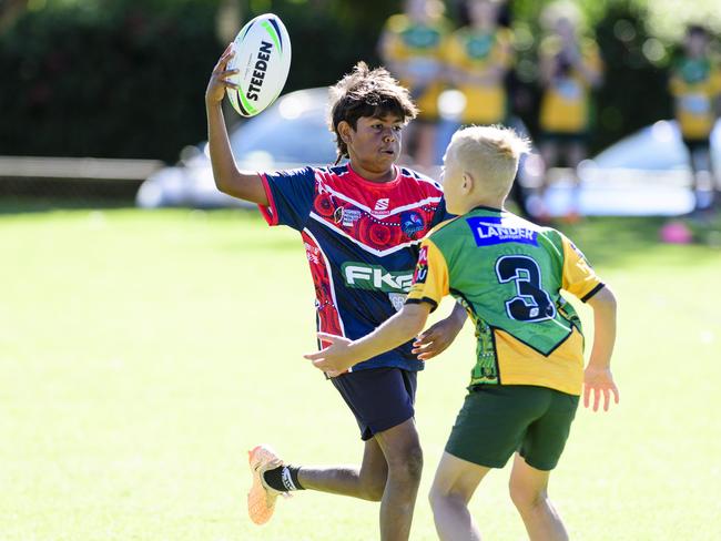 Zac of Harristown State School Blue attempts to evade Fletcher Anderson of Gatton State School in the inaugural Primary Interschools Reconciliation Touch Carnival hosted by Glenvale State School, Wednesday, May 28, 2025. Picture: Kevin Farmer
