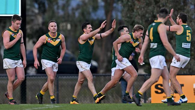 NFL: Old Eltham Collegians players celebrate a goal. Picture: Andy Brownbill