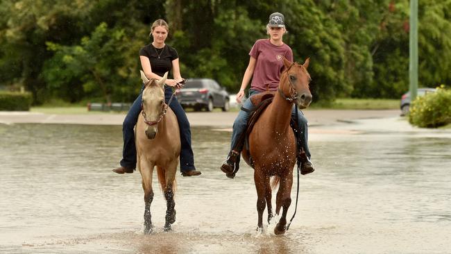 Tuesday February 4. Heavy rain causes flooding in North Queensland. Sisters Mia Bass 15 and Makayla Bass, 18, with horses Harley And Montana go for a ride after four days trapped in home after flooding. Picture: Evan Morgan