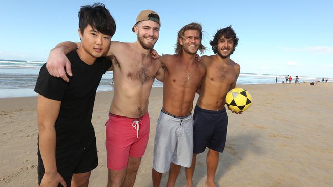 People enjoying themselves on Surfers paradise Beach. L-R Daniel Park of Korea , Raphael Gaudeau of France Pedro Goncalves of Brazil, and Matheus Nery of Brazil. Picture Mike Batterham