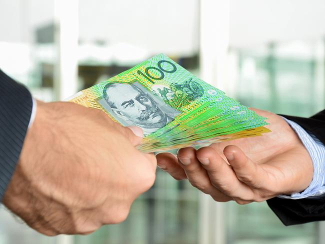 Hands of businessmen passing money, Australia dollar bills