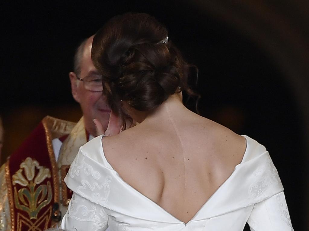 Britain's Princess Eugenie arrives accompanied by her father Prince Andrew, at St George's Chapel for her wedding to Jack Brooksbank in Windsor Castle, Windsor, England, Friday Oct. 12, 2018. (Toby Melville, Pool via AP)