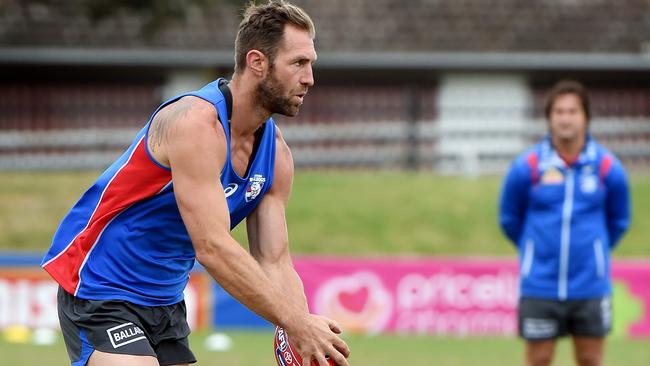 Luke Beveridge watches Travis Cloke take part in Western Bulldogs training. Picture: Nicole Garmston