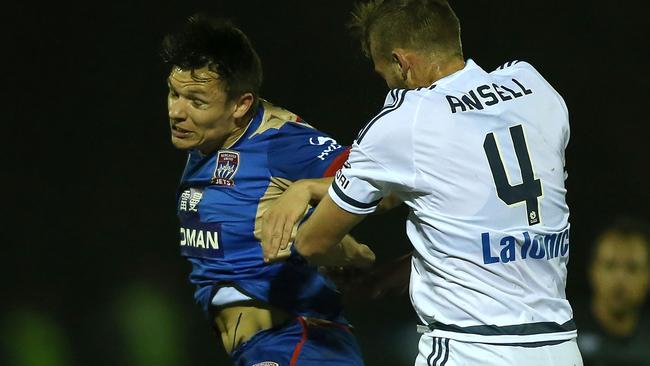 Wayne Brown of the Jets contests the ball with Nicholas Ansell in the FFA Cup.