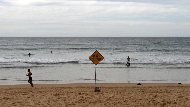 People exercise along Manly Beach during the coronavirus pandemic. Photo Jeremy Piper