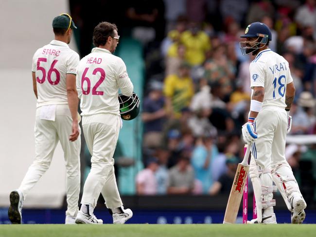 Indiaâs Virat Kohli (R) reacts as Australiaâs Mitchell Starc (L) and Travis Head walk nearby after the third umpire decision regarding a catch by Australiaâs Steve Smith gave him not out during day one of the fifth cricket Test match between Australia and India at The SCG in Sydney on January 3, 2025. (Photo by DAVID GRAY / AFP) / -- IMAGE RESTRICTED TO EDITORIAL USE - STRICTLY NO COMMERCIAL USE --