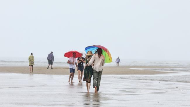 The lowest tide of the year has seen the sandbank off Buchan Point fully exposed out of the water, allowing people to walk halfway to Double Island, about 1 kilometre out from the beach. People brought umbrellas to the beach to brave the wet weather and experience the strange natural phenomenon, which only happens a few times a year. Picture: Brendan Radke