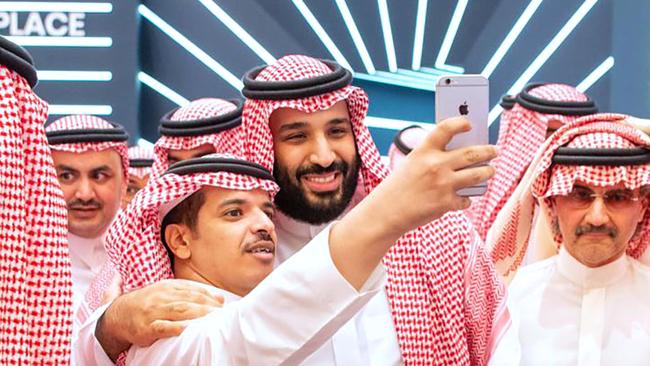 Saudi Crown Prince Mohammed bin Salman (centre) posing for a selfie with an unidentified man near Saudi billionaire Prince Al-Walid bin Talal (R) during the Future Investment Initiative FII conference.