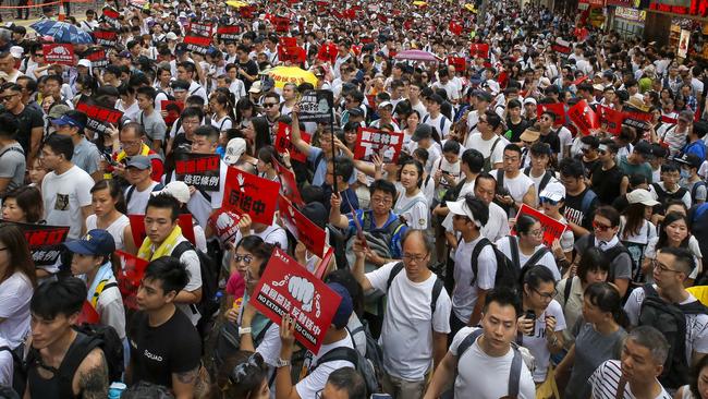 ‘The people’s voices are not being heard’: Placard-carrying protesters in Hong Kong rally against law changes that would allow extradition to China. Picture: AP